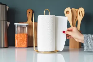 Woman tearing a piece of paper towel from a roll